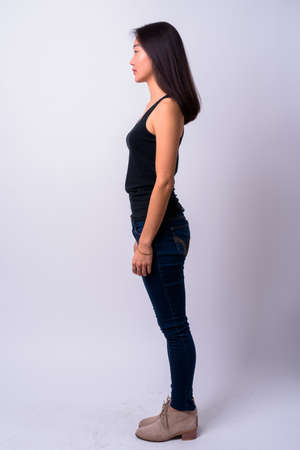 Full body shot profile view of young beautiful Asian womanの写真素材