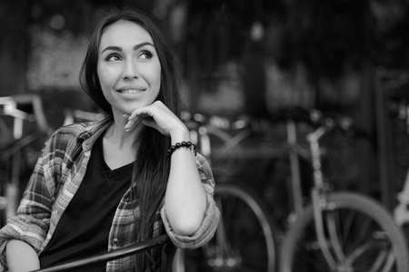 Young beautiful hipster woman in the city streets in black and whiteの写真素材