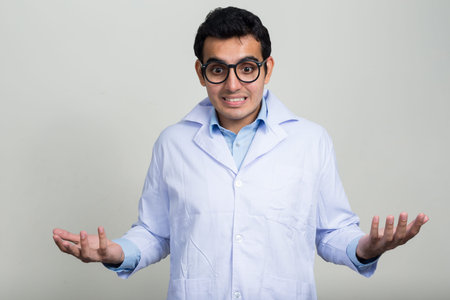 Portrait of stressed young Indian man doctor with eyeglasses