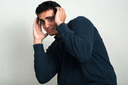 Portrait of stressed young Indian man looking scaredの写真素材