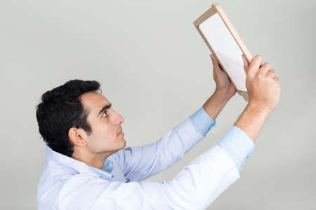 Portrait of young handsome Indian man doctorの写真素材