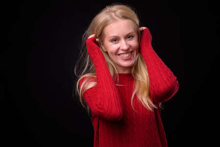 Portrait of happy beautiful woman with blond hair ready for winterの写真素材