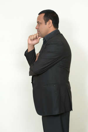 Portrait of overweight Indian businessman in suitの写真素材