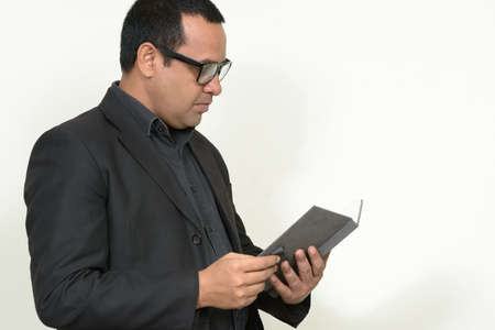 Portrait of Indian businessman in suit with bookの写真素材