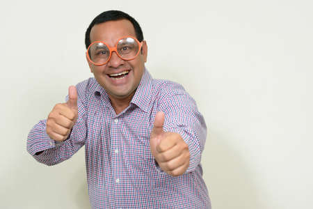 Portrait of happy overweight Indian businessman with eyeglassesの写真素材