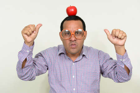Portrait of overweight Indian businessman with appleの写真素材