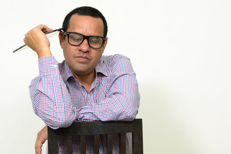 Portrait of overweight Indian businessman with digital tabletの写真素材