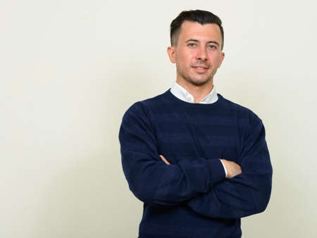 Portrait of young handsome man with arms crossedの写真素材