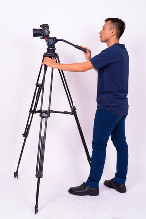 Portrait of young Asian man with camera