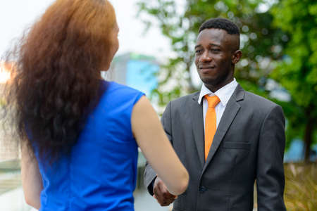 Young African businessman and young businesswoman togetherの写真素材
