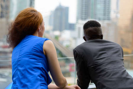 Young African businessman and young businesswoman togetherの写真素材