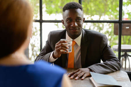 Young African businessman and young businesswoman togetherの写真素材