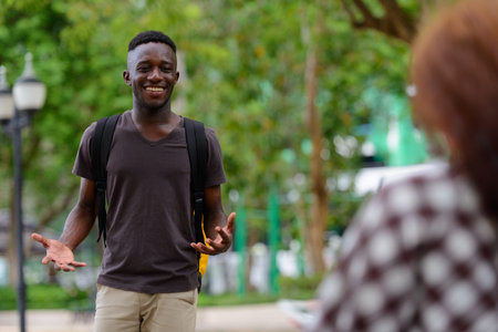 Young African man and young woman with red hair together