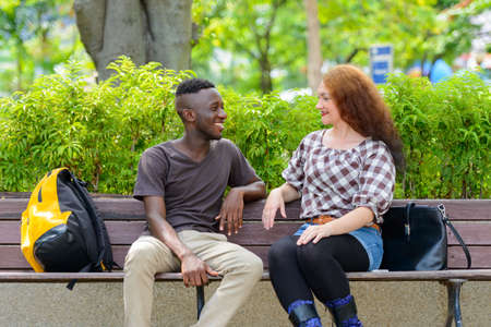Young African man and young woman with red hair togetherの写真素材