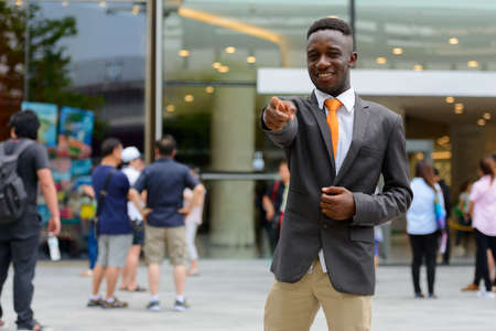 Young African businessman in the city outdoors