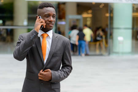 Young African businessman in the city outdoorsの写真素材