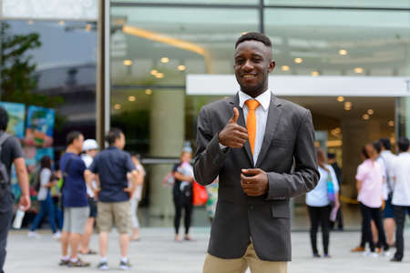 Young African businessman in the city outdoorsの写真素材
