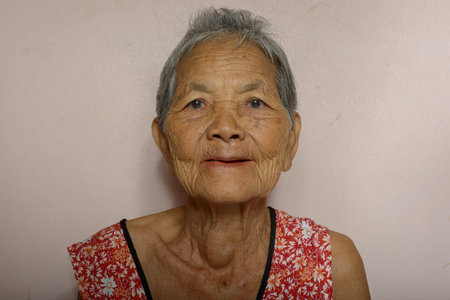 Portrait of happy senior Asian woman with gray hair