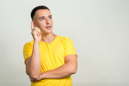 Portrait of handsome man with yellow shirtの写真素材