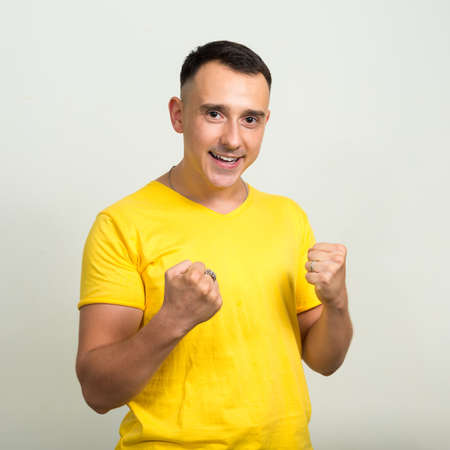 Portrait of handsome man with yellow shirtの写真素材