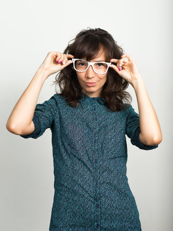 Portrait of beautiful businesswoman with eyeglasses against white background