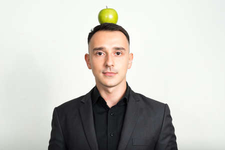 Portrait of handsome businessman in suit against white backgroundの写真素材