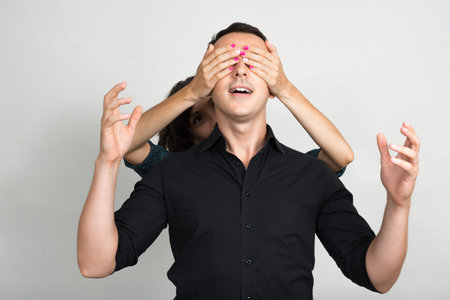 Studio shot of young man and young woman as couple together and in love against white background