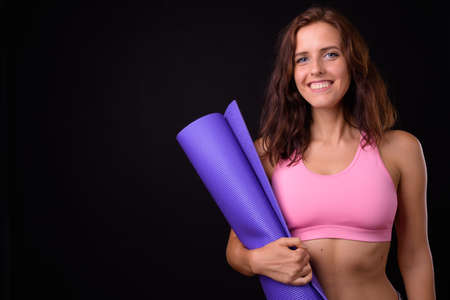 Portrait of happy young beautiful woman ready for gymの写真素材