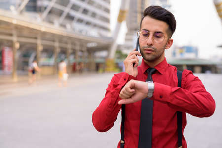 Young handsome Persian businessman exploring the cityの写真素材