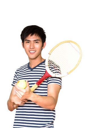 Studio shot of young handsome Asian man holding tennis racket isolated against white backgroundの写真素材