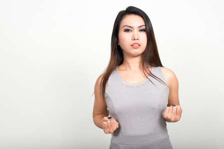 Portrait of Asian woman against white backgroundの写真素材