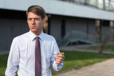 Handsome Scandinavian businessman with blond hair outdoorsの写真素材