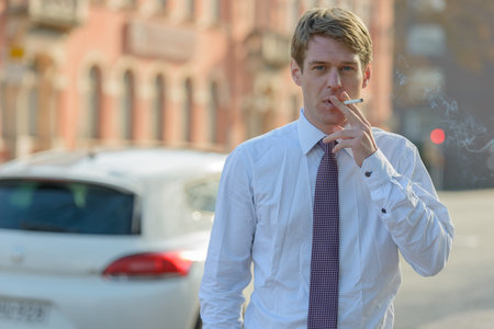Handsome Scandinavian businessman with blond hair outdoors