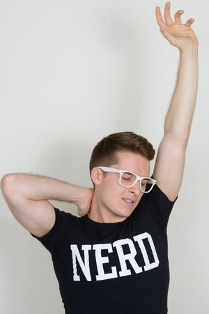 Portrait of young handsome nerd man with eyeglasses