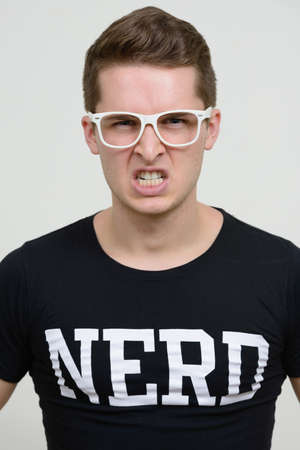 Portrait of young handsome nerd man with eyeglassesの写真素材