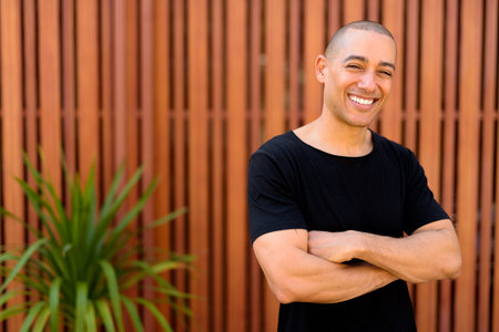 Happy handsome multi ethnic bald man in the streets outdoors