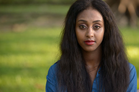 Portrait of young beautiful African woman at the park outdoorsの写真素材