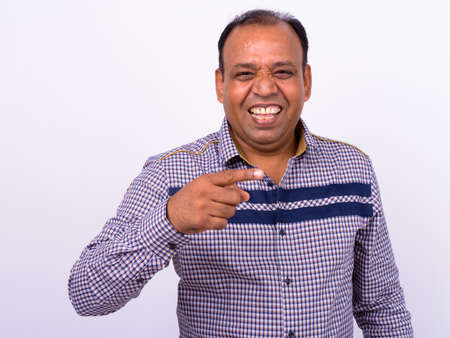 Portrait of happy mature overweight Indian businessmanの写真素材