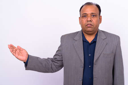 Portrait of mature overweight Indian businessman in suitの写真素材