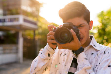 Young handsome Indian teenage boy in the streets outdoorsの写真素材