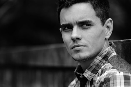 Handsome hipster man in the streets outdoors in black and white