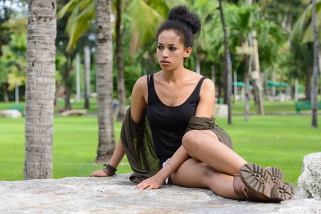Portrait of young beautiful African woman at the park outdoors