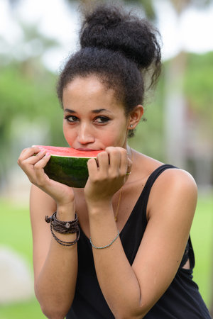 Portrait of young beautiful African woman at the park outdoorsの写真素材