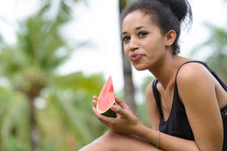 Portrait of young beautiful African woman at the park outdoorsの写真素材