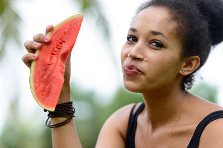 Portrait of young beautiful African woman at the park outdoorsの写真素材
