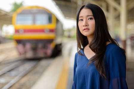 Young beautiful Asian tourist woman at the railway stationの写真素材