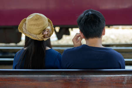 Young Asian tourist couple travelling together at the railway stationの写真素材