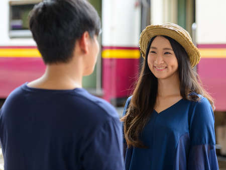 Happy young Asian tourist couple travelling together at the railway stationの写真素材