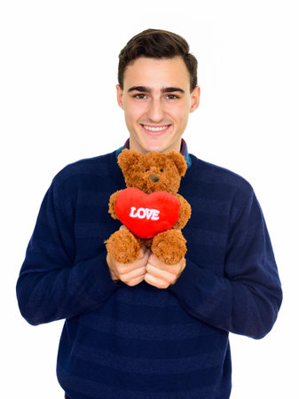 Portrait of happy young handsome man against white backgroundの写真素材