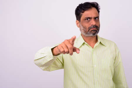 Portrait of mature handsome bearded Indian businessmanの写真素材
